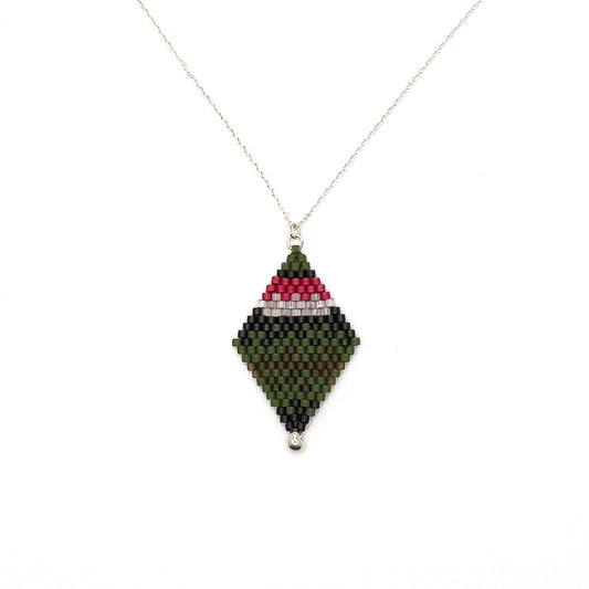 Handcrafted beaded pendant with a sterling silver chain inspired by the Ruby Throated Hummingbird, featuring a bold pink, white, and green beaded design at the top that flows into layered green and brown beads laying on a white background.